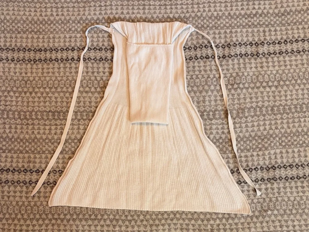 Step 3: The nappy turned over, with the folded panel visible and the ties at the top.
