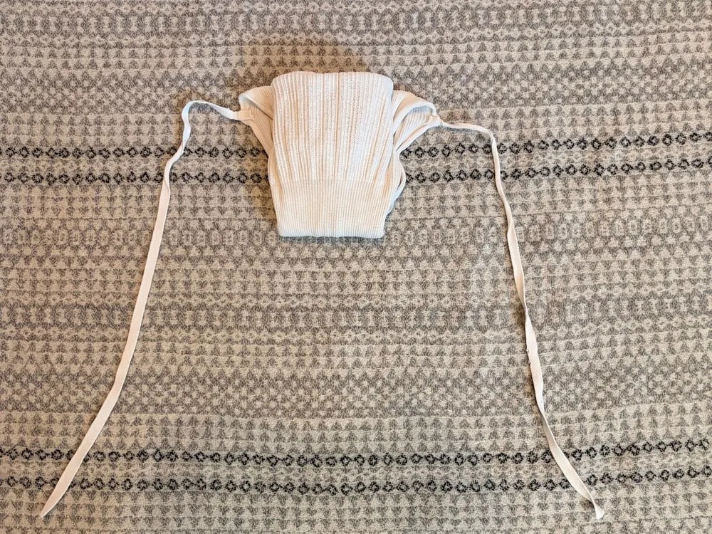 Step 8: The front folded up, with the ties extending out to either side, ready to fasten.
